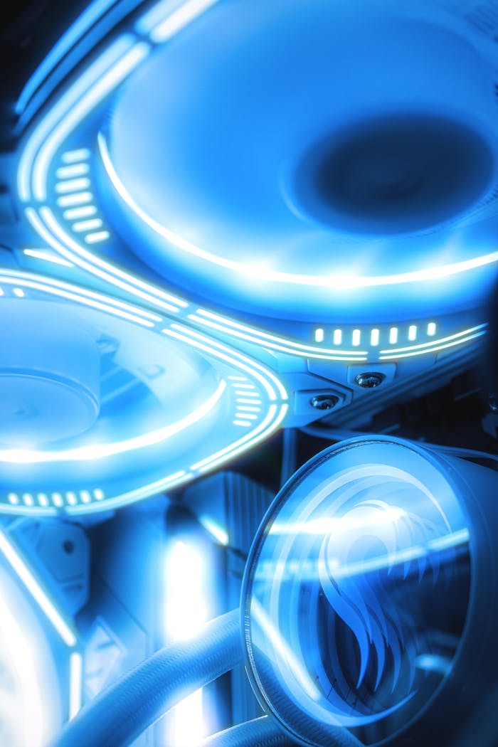 Vivid close-up of illuminated computer cooling fans showcasing modern technology and vibrant blue neon lighting.